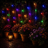 Colorful string lights hanging above potted flowers in a garden setting