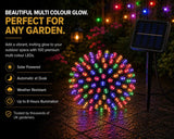 Multicolored string lights with solar panel on a garden path, text highlighting features.