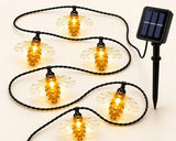 Solar powered bee-shaped string lights on a white background