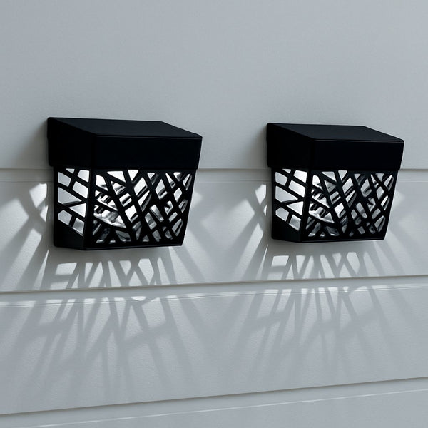 Two black wall-mounted outdoor lights with geometric patterns on a light gray background.