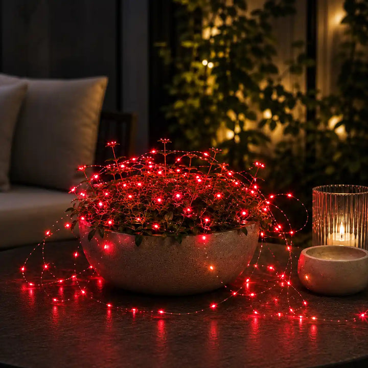Red micro string lights on outdoor dining table