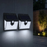 Two solar-powered outdoor lights attached to a wall with a night scene in the background.