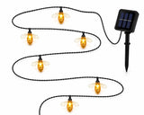 Solar string lights shaped like bees with a solar panel on a white background