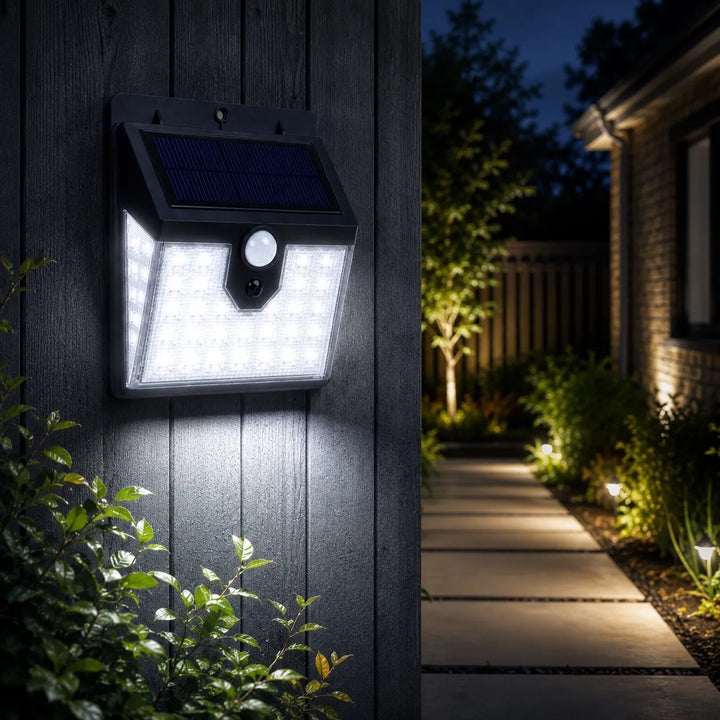 Solar-powered outdoor light fixture on a wooden wall with pathway and garden in the background