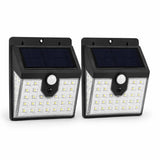 Two solar-powered motion sensor lights on a white background