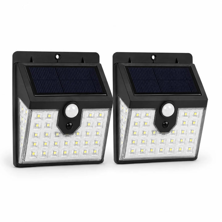 Two solar-powered motion sensor lights on a white background